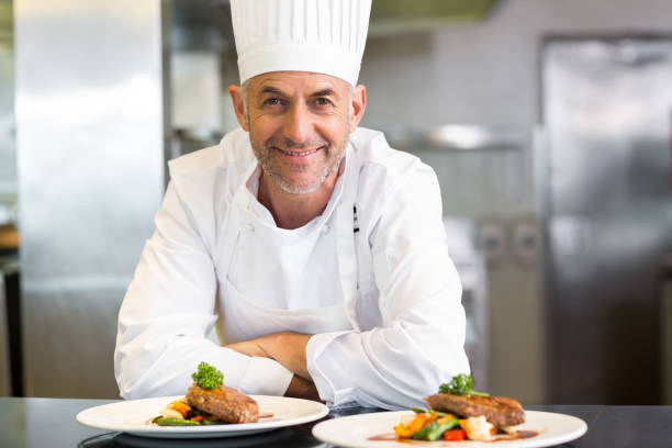 istock Confident male chef with cooked food in kitchen 690797016