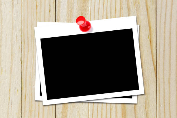istock Some blank black polaroids pinned on the wood background 690797226