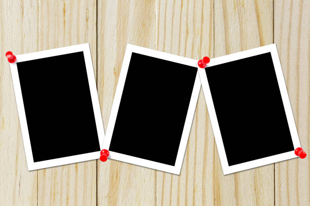 istock Some blank black polaroids pinned on the wood background 690797228