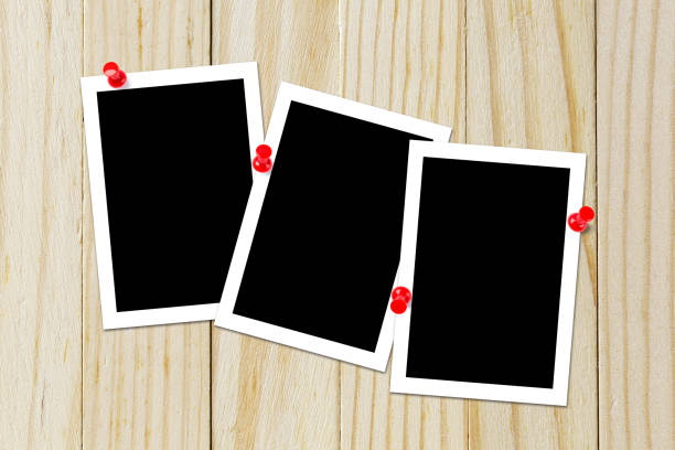 istock Some blank black polaroids pinned on the wood background 690797232