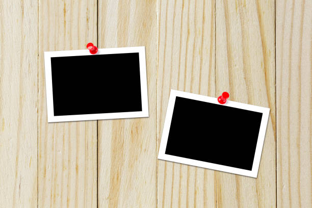 istock Some blank black polaroids pinned on the wood background 690797236