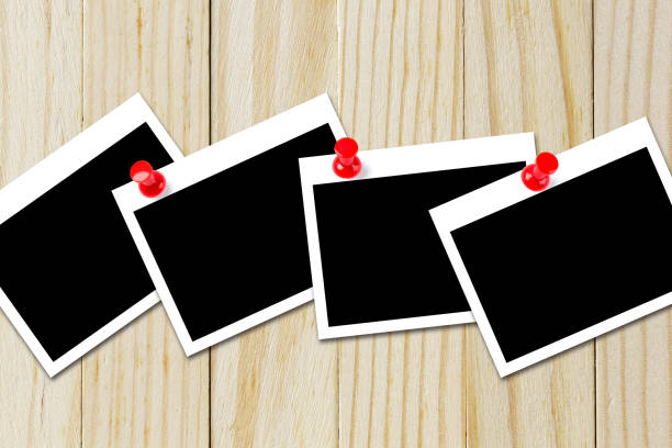 istock Some blank black polaroids pinned on the wood background 690797270