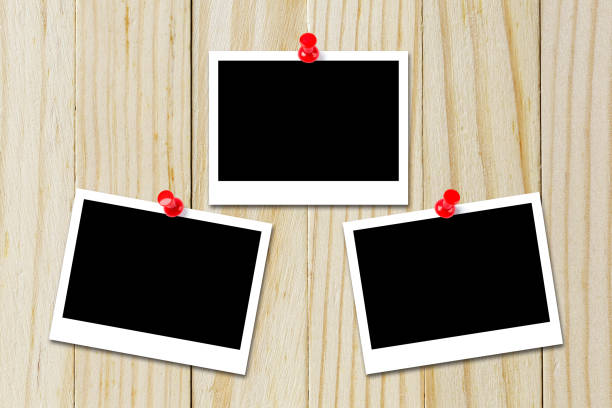 istock Some blank black polaroids pinned on the wood background 690797284