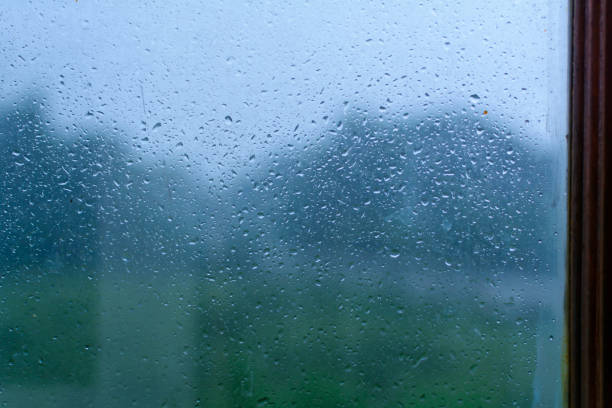 istock Droplet bokeh and rain on a glass background 690800140