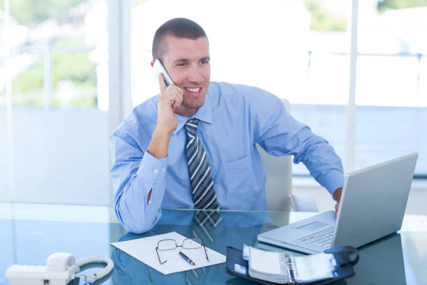istock Smiling businessman having a phone call 690800730