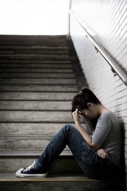 istock depressed woman in underground 690800786