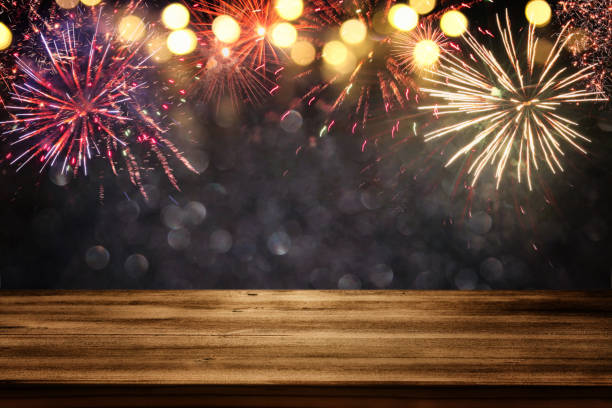 istock Empty wooden table in front of fireworks background 690810438