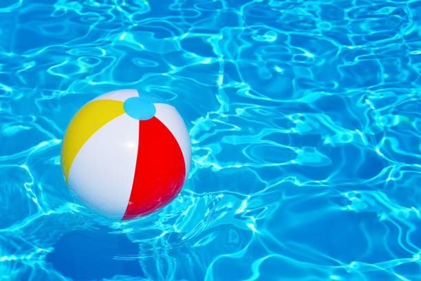 istock Colorful inflatable ball floating in swimming pool 690822660