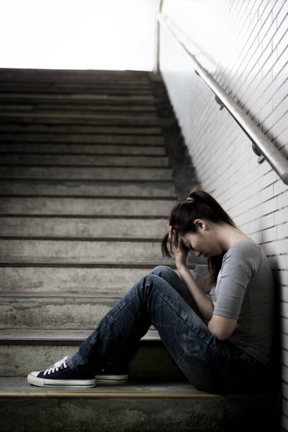 istock depressed woman in underground 690822722