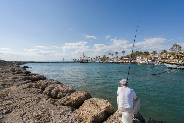 May 25, 2017 The man is fishing in Side harbor Antalya Turkey.