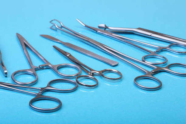 istock Close Up Surgical instruments and tools on blue mirror background. Selective focus. 690825958