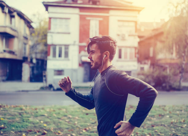 istock Young man jogging in the city 690830250