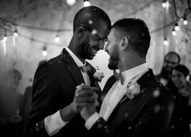 Photo of Newlywed Gay Couple Dancing on Wedding Celebration