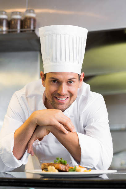 istock Smiling male chef with cooked food in kitchen 690837914