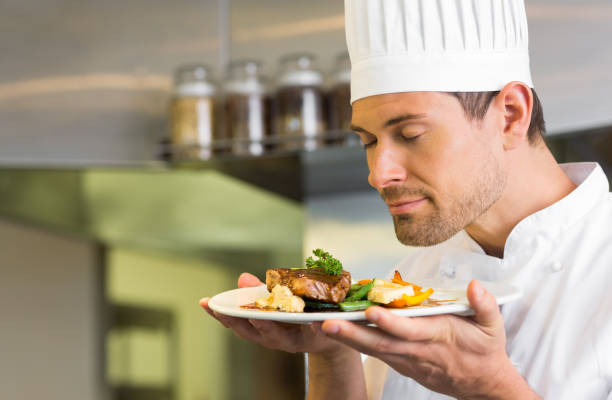 istock Male chef with eyes closed smelling food 690838146