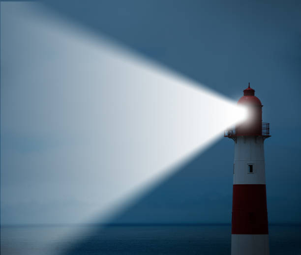 istock Lighthouse in action with beam, sea in background 690841614