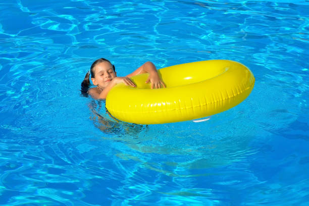 istock Adorable toddler relaxing in swimming pool 690841666