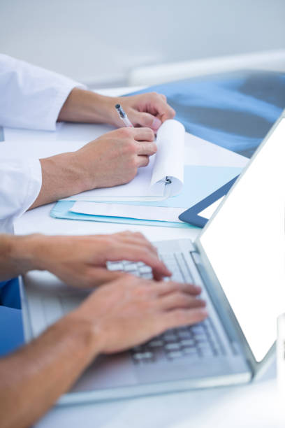 istock Medical colleagues working with laptop and taking notes 690841844