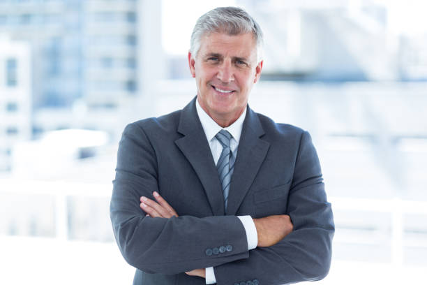 istock Smiling businessman with arms crossed 690845000