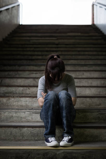 istock depressed woman in underground 690845364