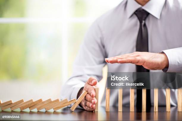 Protecting Assets From Domino Effect Stop Loss Concept Stock Photo - Download Image Now
