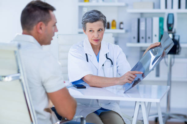 istock Doctor showing X rays to her patient 690845686