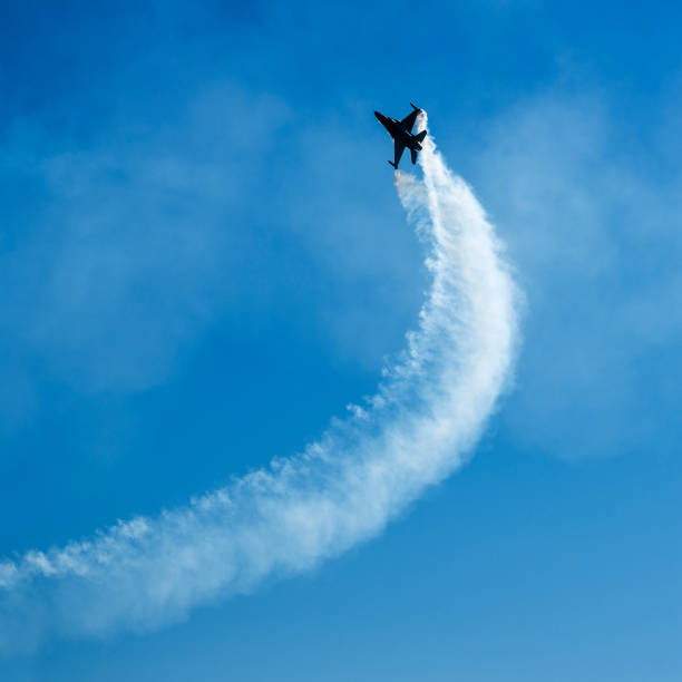 Fighter Jet performing air show Fighter Jets performing air show, low angle view, Blue sky, Copyspace airshow photos stock pictures, royalty-free photos & images