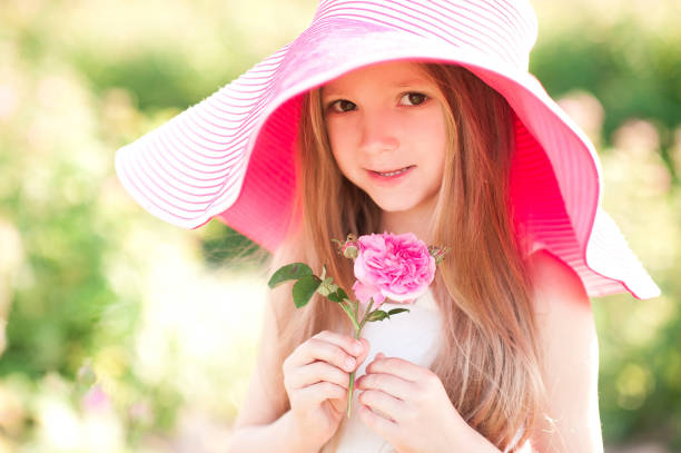 istock Kid girl with rose 690853024
