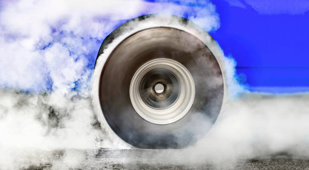 Drag racing car burns tires for the race Drag racing car burns rubber off its tires in preparation for the race car burnout stock pictures, royalty-free photos & images