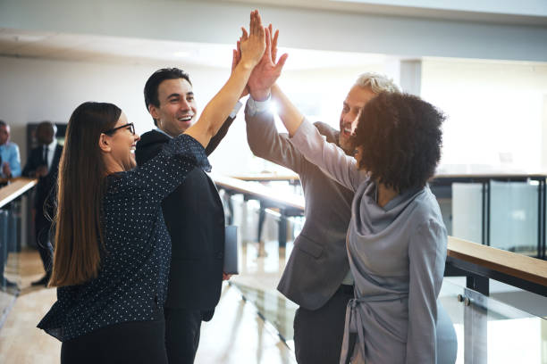 istock Cheerful multiethnic office team giving high five 690855606