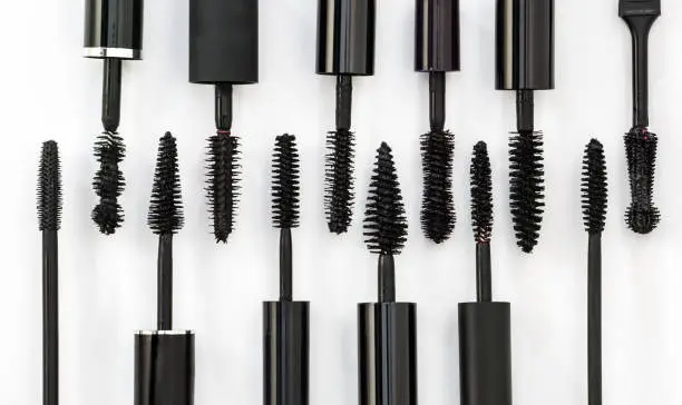 row of different mascara brushes on a white background. Cosmetic concept