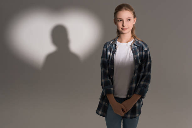 istock adorable girl standing in studio with heart shaped shadow 690865496