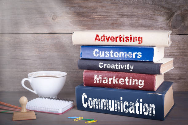 istock Advertising concept. Stack of books on wooden desk 690875814