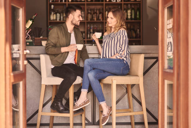 バーのカウンターでカップルの完全な長さ - drinking couple bar counter bar ストックフォトと画像