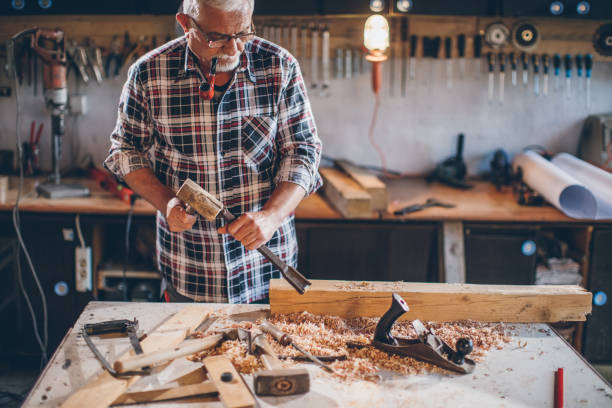 istock Photo of a senior carpenter at work 690879610