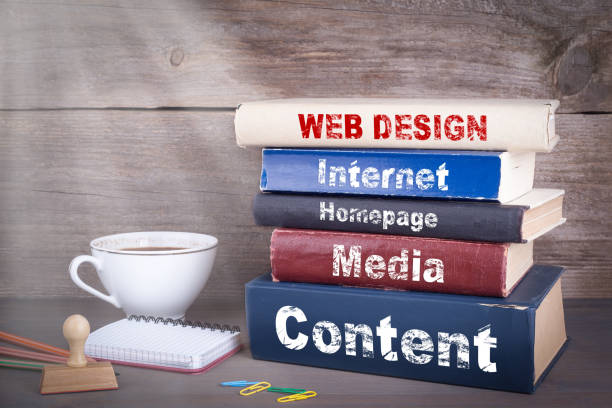 istock web design concept. Stack of books on wooden desk 690879754