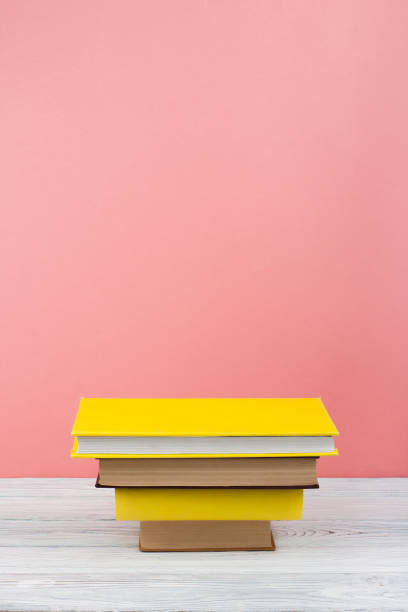 istock Book stacking. Open book, hardback books on wooden table and blue background. Back to school. Copy space for text 690879918