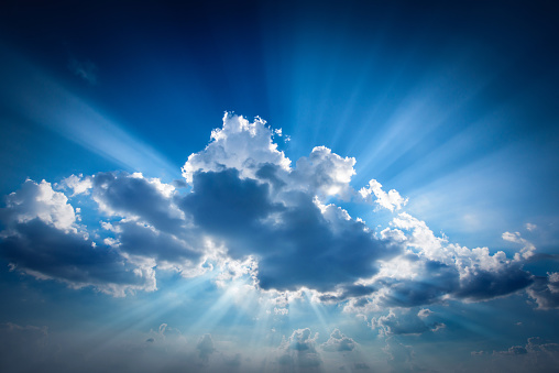 The sun's rays make their way through the cloud