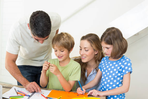 istock Happy family coloring at home 690882662
