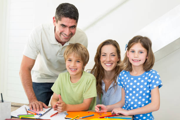 istock Smiling family coloring at home 690882704