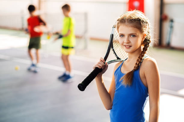 istock Excited kid playing tennis on playground 690883580