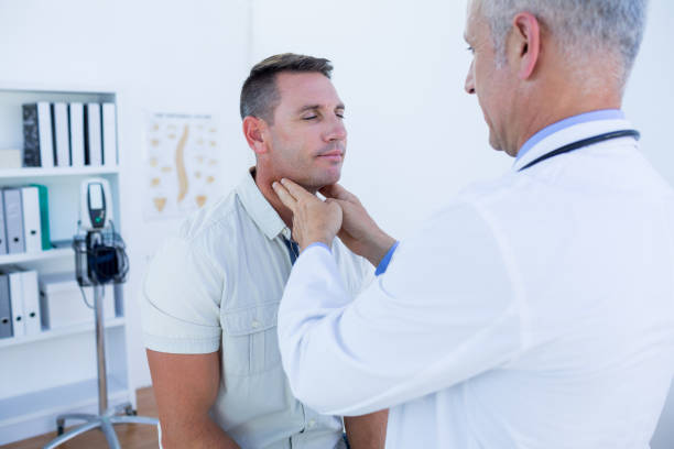 istock Doctor examining his patient neck 690886376