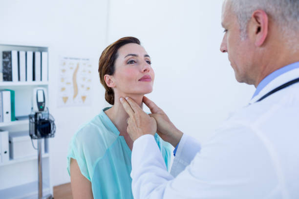 istock Doctor examining his patient neck 690886538