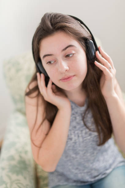 istock Thirteen Year Old Listening to Music or Podcast 690886954