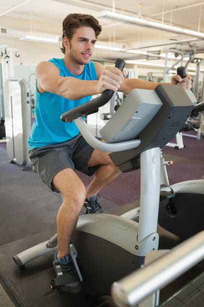 istock Smiling fit man on the exercise bike 690887064
