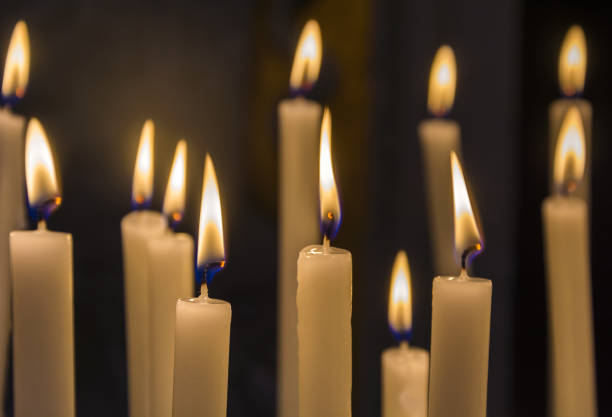 istock burning candles in catholic church on dark background closeup image 690887338