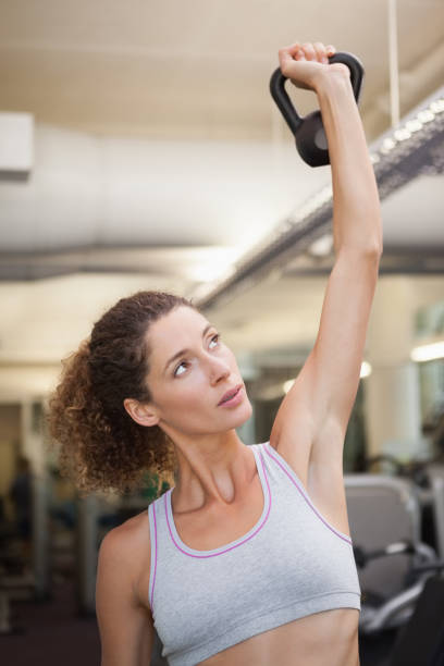 istock Fit woman lifting up kettlebell 690890398