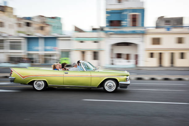 Havanna, Cuba - January 22, 2017: A longexposure of a vintage car driving at the Malecon with tourists on board.