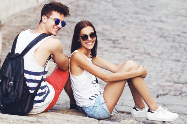istock Two young tourists sightseeing a city, holding a map, pointing with finger 690899706