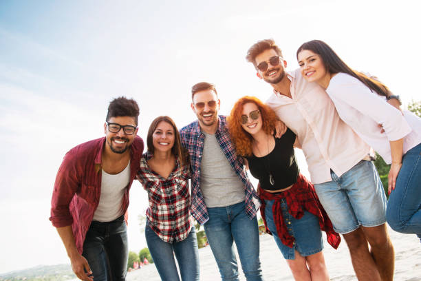 istock Group of young people having fun outdoors on the beach 690900090